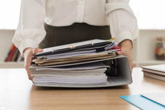 Working women at her office with many documents.