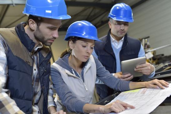 Industrial engineers meeting in mechanical factory