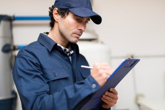 Technician fixing an hot-water heater