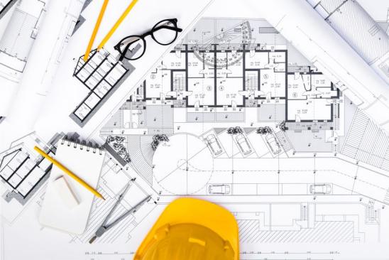 Top View of Construction plans with Tablet, drawing and working Tools on blueprints; Architectural and Engineering Housing Concept.