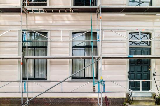 Restoration and painting of an ancient Dutch wooden house in North Amsterdam